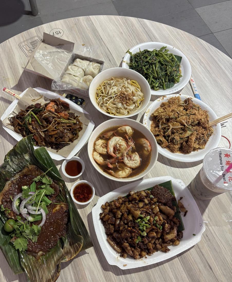 A table full of dishes at a hawker centre in Singapore