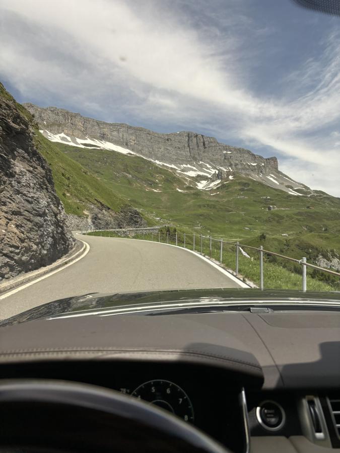View from the driver’s seat on a winding Alpine pass road