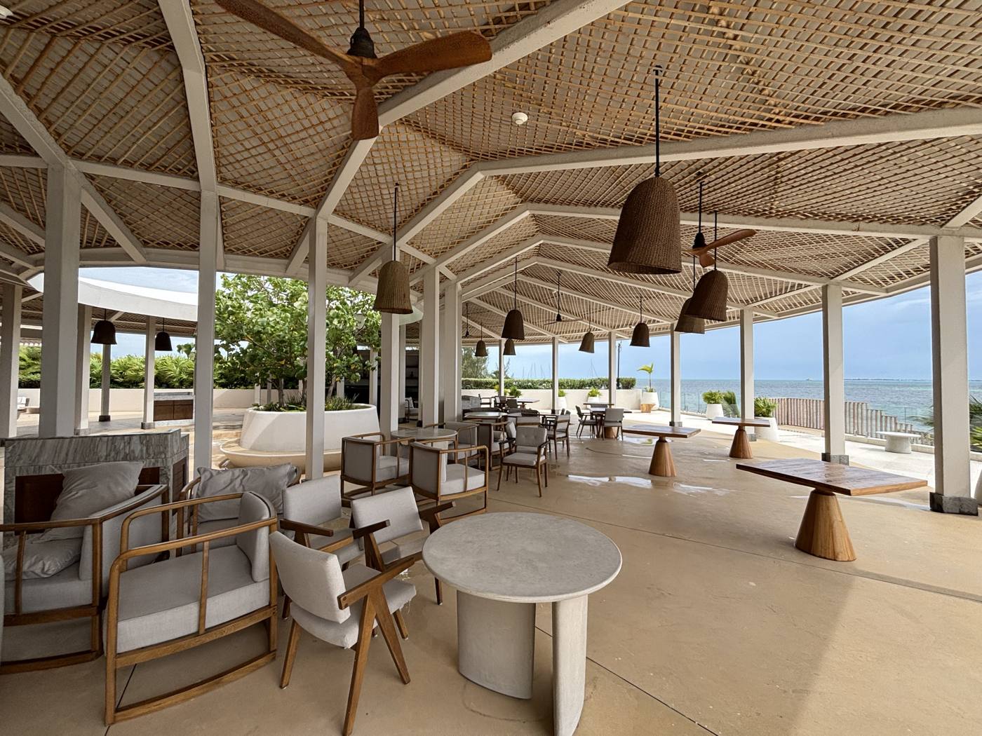 A shaded terrace with seating over the water