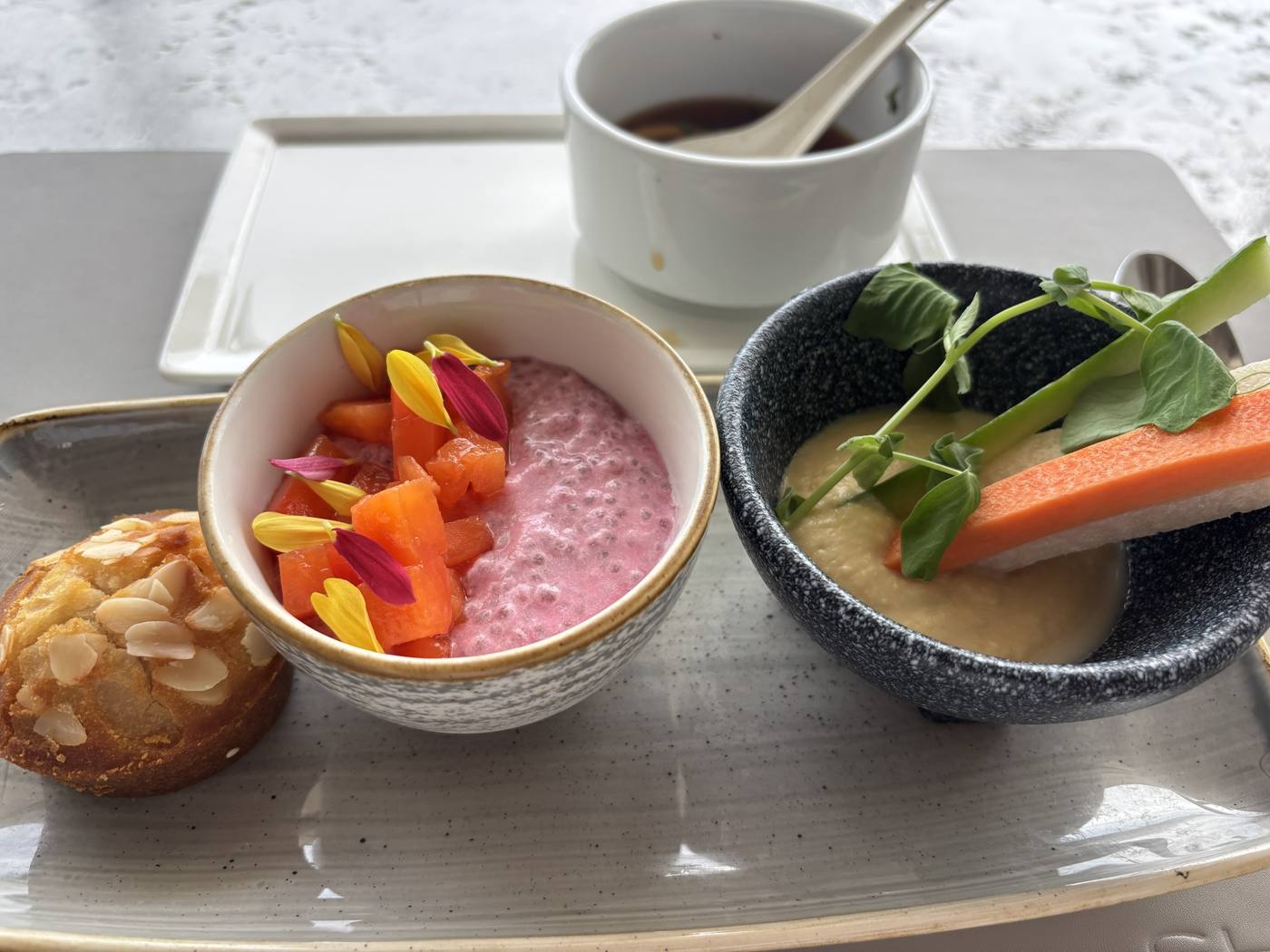 Breakfast: beet chia pudding with papaya, hummus with crudités, an almond muffin, and the day's miso soup