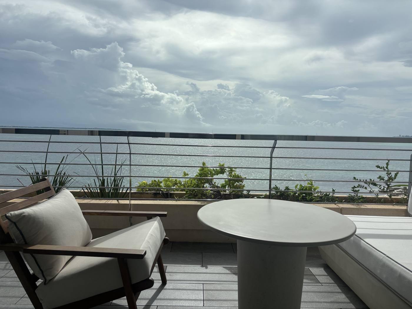 The balcony, with a daybed, a chair, and this view